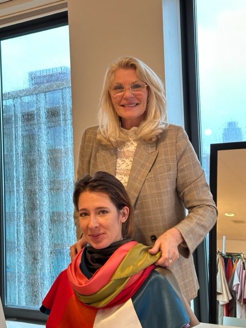 Kleurstylist doet kleurdoeken om nek van vrouw